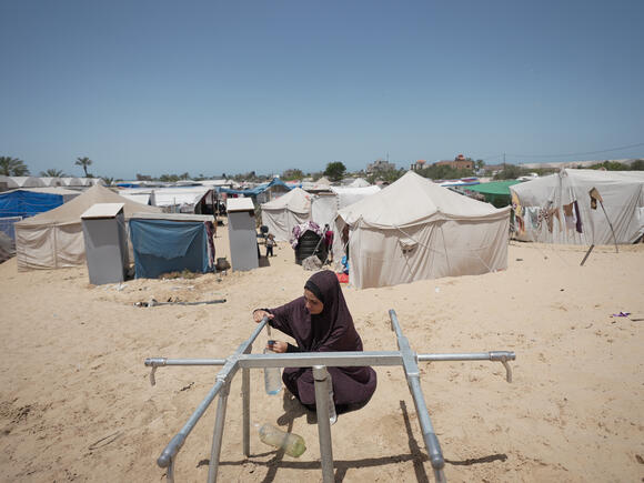 gaza women taking water from tap installed by Oxfam