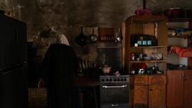 Abeer, who once benefited from the women's workshops, stands in her kitchen in her home in the village of al-Hadidiyah in the Jordan Valley Samar Hazboun