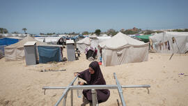 gaza women taking water from tap installed by Oxfam